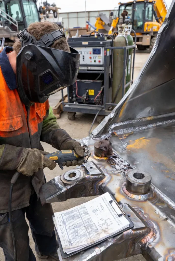 2 a certified welder performing a structural assessment and weld repair on a hardened-steel