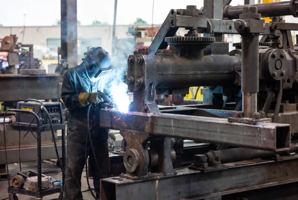 4 CanaWelding crew welding a cracked bracket on industrial equipment at a Mississauga manufacturing yard