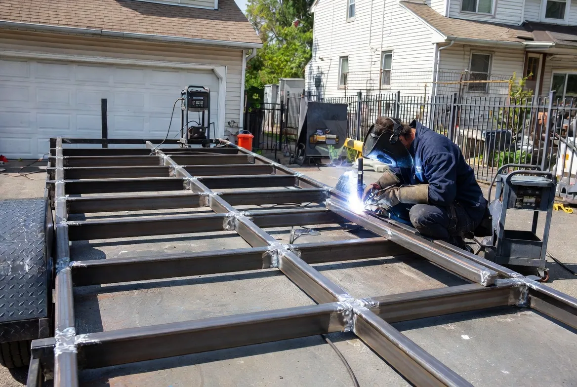 CWB-certified welder repairing a cracked trailer frame