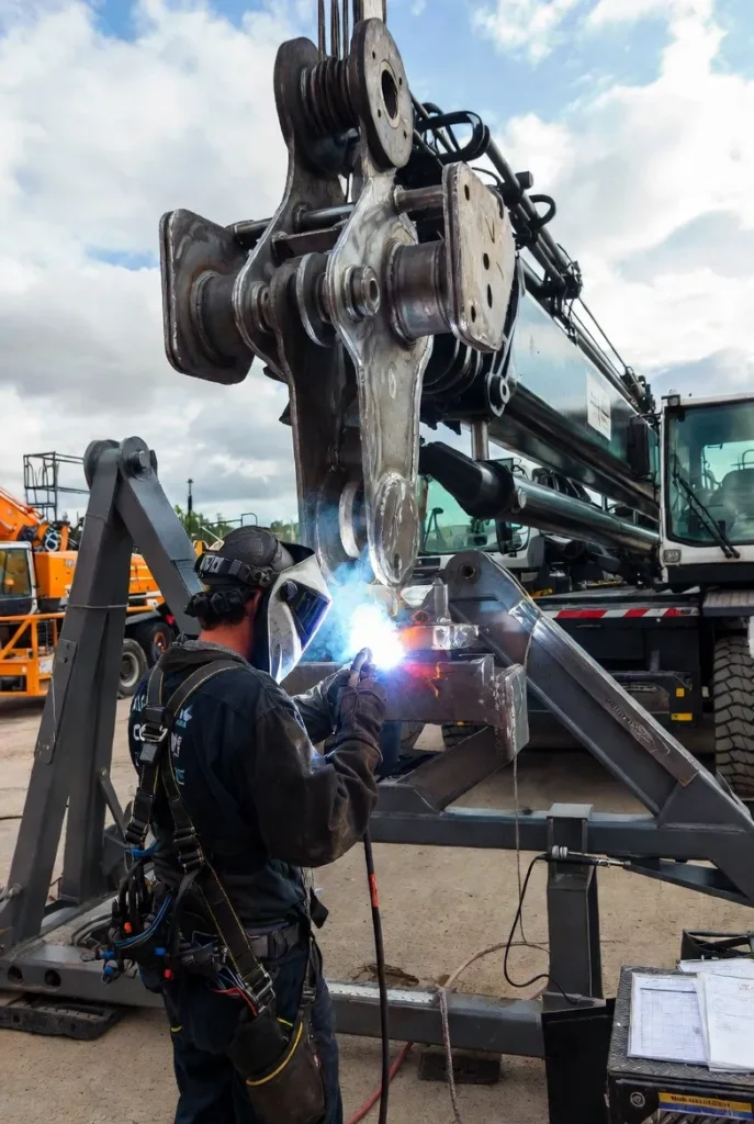5 CWB-certified welder executing precise TIG MIG welds on a mobile crane boom section at a GTA job site